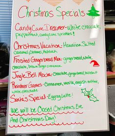 a white board with christmas specials written on it in green and red writing, along with other holiday themed items