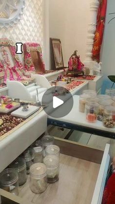 a living room filled with lots of furniture and jars on top of a wooden table