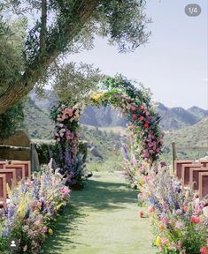 an outdoor ceremony with flowers and greenery