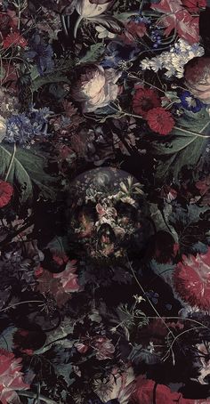 a skull surrounded by flowers and leaves on a black background with red, pink, blue, white and green colors