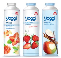 three bottles of yogurt with strawberries and apples