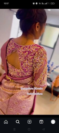 the back of a woman's dress in pink and gold with an intricate design on it