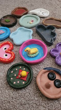 there are many plastic plates and toys on the floor, including one with a rubber duck