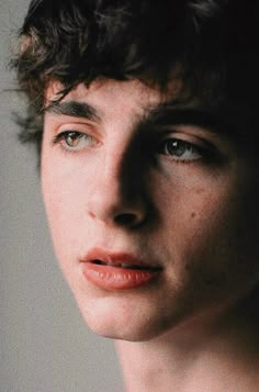 a young man with freckled hair and blue eyes