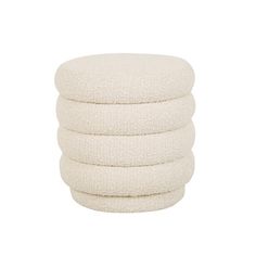 four white round cushions stacked on top of each other in front of a white background