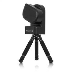 a tripod with a black speaker on it's head and the camera attached to it