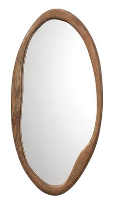 an oval wooden mirror hanging on the wall next to it's reflection in a white background