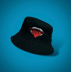 a black hat with a red mouth and teeth on the front, against a blue background