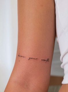 a woman with a tattoo on her arm that says, because you're worth