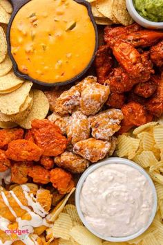 an assortment of snacks and dips on a platter