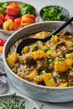 a white bowl filled with stew and vegetables