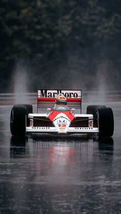 a man driving a race car on top of a lake