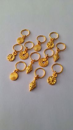 Loc jewelry made with 11 matte gold covered brass charms on brass rings.  Rings fit all locs and braids. Gold Braid Jewelry, Gold Hair Jewelry For Braids, Bohemian Gold Nose Rings Nickel Free, Bohemian Gold Nickel-free Nose Ring, Gold Bohemian Nickel-free Nose Ring, Nickel-free Gold Metal Nose Rings, Grad Jewelry, Braid Rings, Boho Hair Wrap