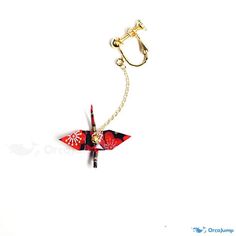 a red and black origami airplane keychain hanging from a gold chain