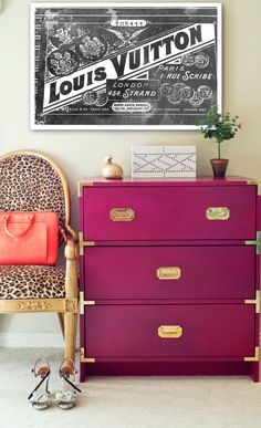 a purple dresser with leopard print on it and a red purse sitting next to it