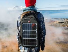 a person wearing a backpack with a solar panel on it