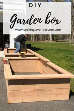 a man working in a garden box with the words diy garden box above it