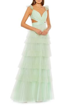 Look every part the princess in this tiered tulle gown that features waist-wrapping cutouts and fluttery, sequinned cap sleeves. 61" length Deep V-neck Cap sleeves Lined 100% polyester Spot clean Imported Asian Owned/Founded Ruffle Skirt Long, Mode Purple, Mac Duggal Prom, Tiered Tulle Skirt, Long Formal Dress, Prom Long, Mac Duggal Dresses, Unique Prom Dresses, Column Gown