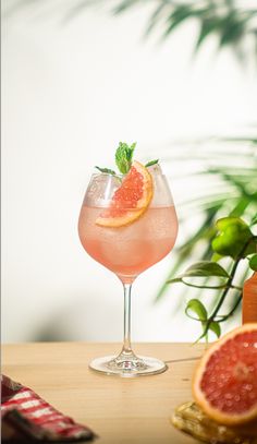 a grapefruit cocktail is garnished with mint