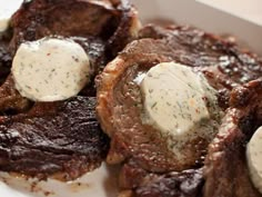 steaks with white sauce and herbs in a box