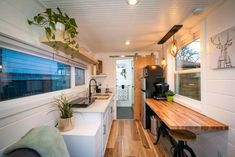 the kitchen is clean and ready to be used as a dining area in this tiny home