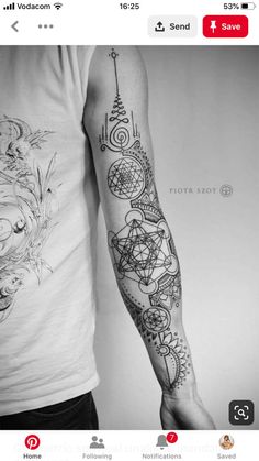 black and white photo of a man's arm with an intricate tattoo design on it