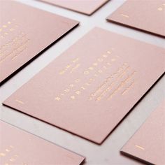 pink and gold foiled business cards on top of each other with the words,