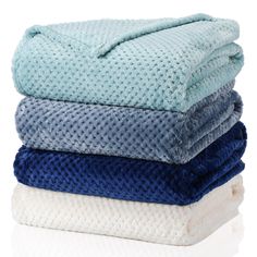 four towels stacked on top of each other in blue, white and light green colors