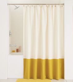 a white and yellow shower curtain in a bathroom