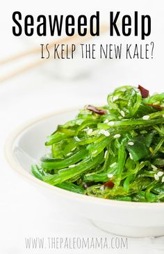 a white bowl filled with green vegetables on top of a table