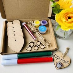 an open box filled with crafting supplies and flowers