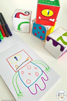 children's art project with cubes and crayons on white table top