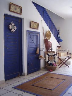 a room with blue doors and rugs on the floor