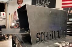 a metal box with the word schnulella on it in front of an american flag