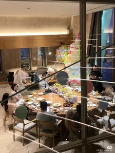 a group of people sitting around a table eating