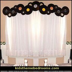 there is a window with vinyl records hanging on the curtain rod in front of it