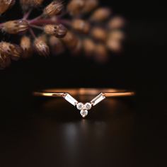 "This stunner chevron band features a 3 round diamond cluster at the apex with 2 slant baguette cut diamonds forming the slopes. Great for round engagement rings, it can be custom fit for other shapes as well.  *  Gold: 14k / 18k Solid Gold  *  Gold Color: Yellow / Rose / White  *  Gold Wt.: ~1 gm (14kt) *  Gemstone: Natural Genuine Diamond *  Total Diamond Wt.: ~0.05 Ct  *  Color-Clarity: G-H-I, Vs-Si   *  Authenticity Check: This ring will be marked for gold and will come with EGL (or equivalent) Certification PLEASE NOTE: - White gold CONTAINS NICKEL.  - Yellow and Rose Gold NICKEL FREE.  - White and Yellow Gold pieces are RHODIUM PLATED. Please mention if you prefer otherwise.  - Rose Gold pieces are NOT RHODIUM PLATED.  PACKAGING: > Each package includes a jewelry box. SHIPPING: > Imp Diamond Band Stack, Chevron Wedding Ring, Baguette Diamond Band, Chevron Wedding, Round Engagement, Round Engagement Rings, Cluster Engagement Ring, Baguette Cut Diamond, Unique Ring