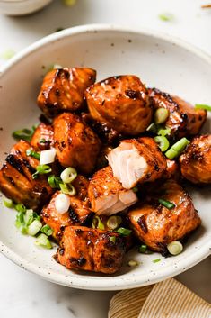 a white bowl filled with meat and vegetables