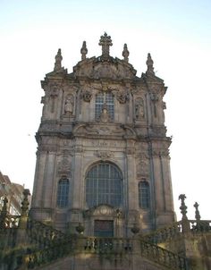 two people standing in front of an old building