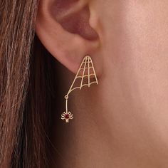 Embrace the Halloween spirit with these 14k Solid Gold Spider Web Earrings, crafted for a minimalist yet spooky design. These dangling earrings are customizable and handcrafted for women who enjoy unique holiday-themed jewelry. Perfect for the holiday season or everyday wear, they offer a striking balance between festive charm and timeless elegance. Features * Gold KT: 14K * Custom Gold Color: Yellow Gold * Web Width: 12.80x22.25mm * Charm Length: 12.30mm Gemstone Details * Lab Grown Gemstone * Spider Web Earrings, Minimalist Halloween, Spooky Designs, Vermeil Jewelry, Halloween Spirit, Halloween Earrings, Themed Jewelry, Handmade Holiday, Dangling Earrings