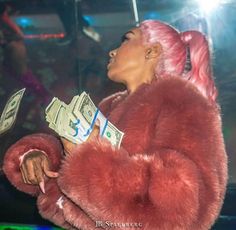 a woman with pink hair and money in her hand