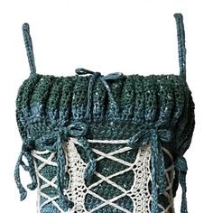 a crocheted bag with white and green trimmings on the front side