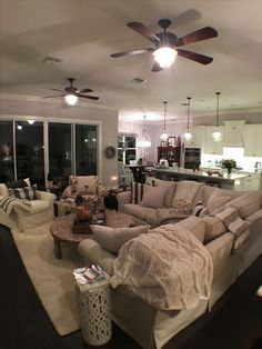 a living room filled with furniture and lots of windows