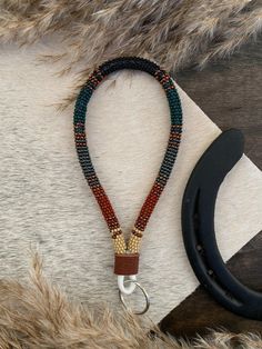 a pair of scissors and a beaded necklace on top of a cowhide rug