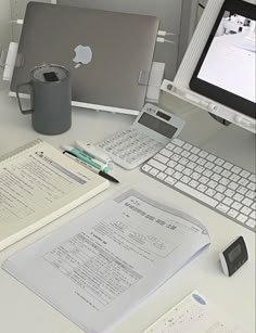 an apple computer sitting on top of a white desk next to a keyboard and mouse