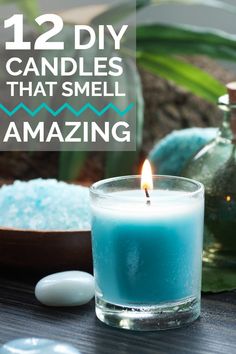 a blue candle sitting on top of a table next to some sea salt and a bottle