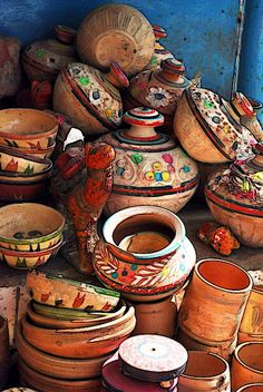 many pots and bowls are stacked on top of each other