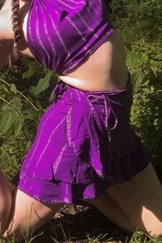 Purple Passion Tie Dye Wrap Skirt made of 100% cellulose rayon. Ruffle trim at bottom for flirty feminine vibe. One size fits most. Skirt is approx. 17.5" from top to bottom and 46" around, so fits up to 40" waist and hips. Additional string approx. 25" on each to wrap around. *All measurements approximate as each one is hand cut and hand sewn. Hand tied and dyed, will be similar to photos. Rich purple tone with lighter lavender streaks tie dyed throughout vertically. The Island Collection inclu Tribe Clothing, Purple Tone, Wrap Skirts, Wrap Mini Skirt, Rich Purple, Halter Tops, Stunning Outfits, Tie Dyed, Wrap Skirt