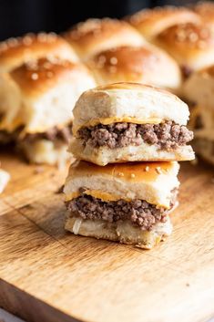 three hamburger sliders stacked on top of each other with cheese and meat in between them