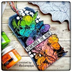 a card with some flowers on it next to other crafting supplies and items that include paint